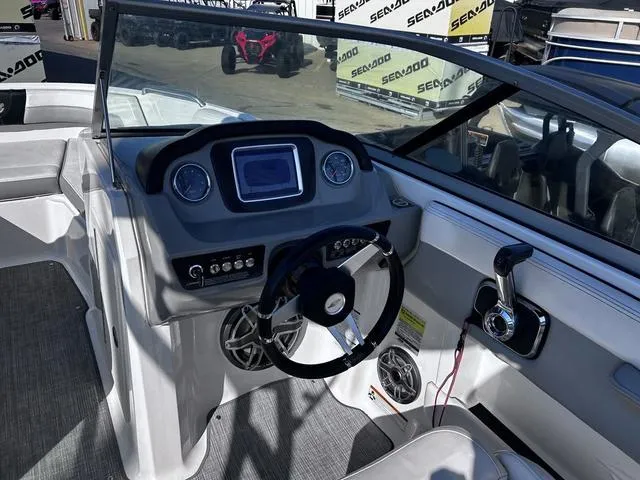 Slide: The Image of 2020 Chaparral 21 Surf boat dashboard with steering wheel and controls. - 6