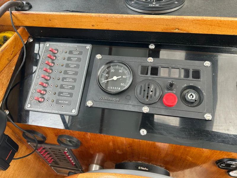 Slide: The Image of Control panel of a 1975 Fisher 30 Motorsailer with gauges and switches. - 12