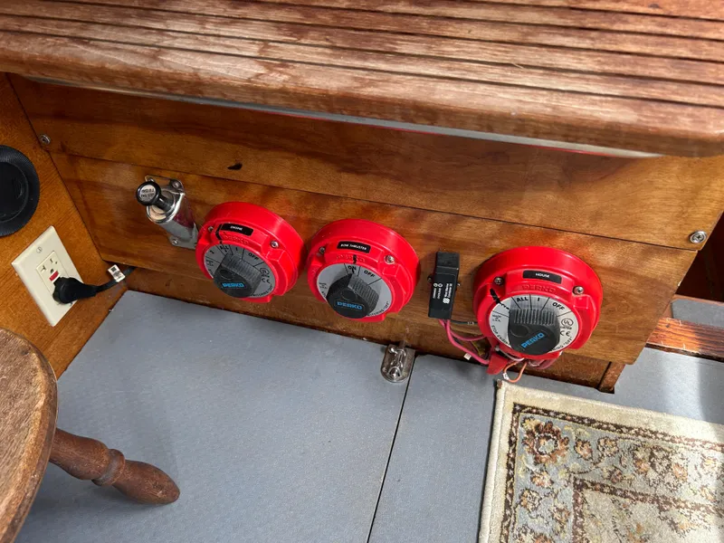 Slide: The Image of Control panel of a 1975 Fisher 30 Motorsailer with red dials and wooden finish. - 14