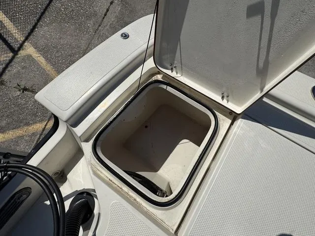 Slide: The Image of Open storage compartment on a 2014 Frontier Boats 2104. - 13