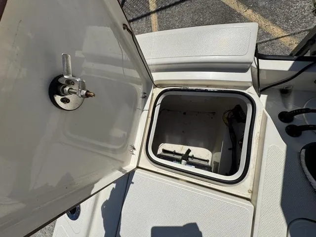 Slide: The Image of Open storage compartment on a 2014 Frontier Boats 2104, showing interior details. - 14