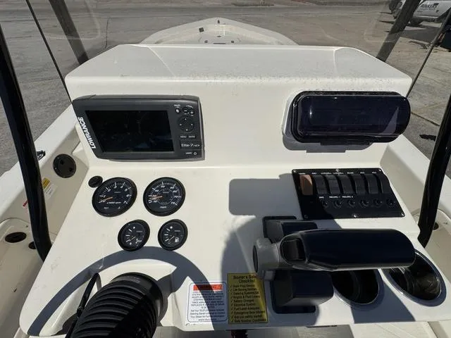 Slide: The Image of Control panel of a 2014 Frontier Boats 2104 with gauges and navigation system. - 16