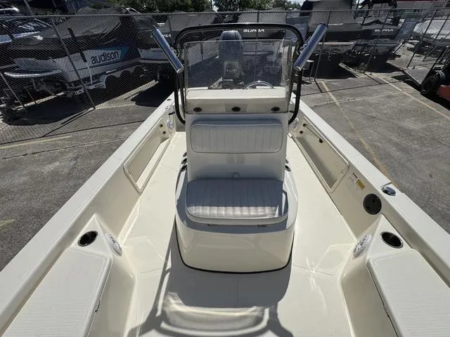 Slide: The Image of 2014 Frontier Boats 2104 center console with seating, docked in a marina. - 18