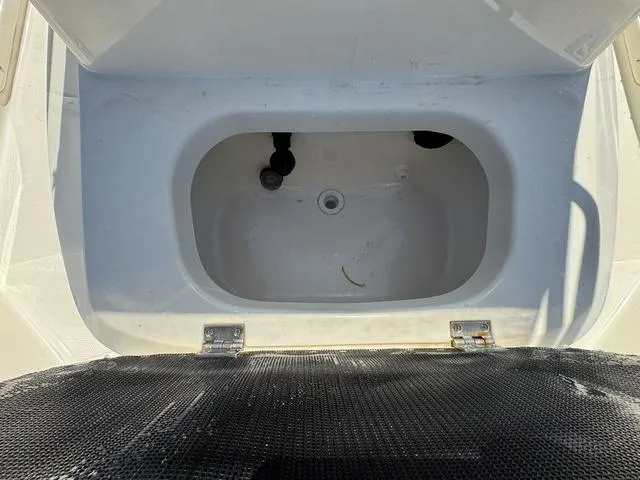 Slide: The Image of Livewell compartment in a 2014 Frontier Boats 2104, open and empty. - 19