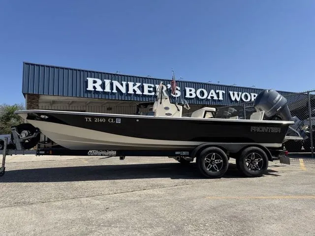 Slide: The Image of 2014 Frontier Boats 2104 on trailer at Rinker's Boat World dealership. - 2