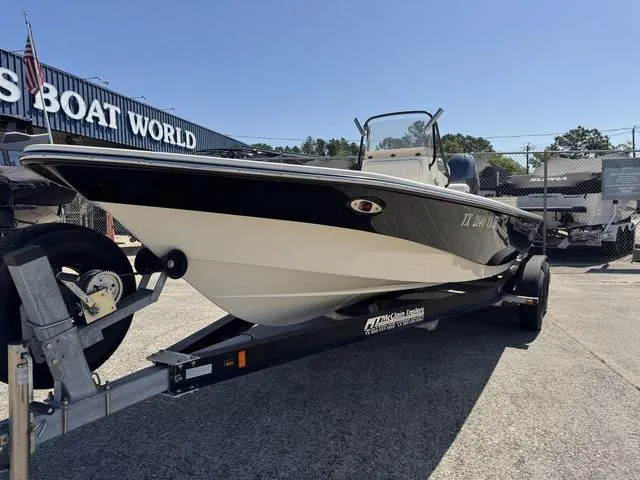 Slide: The Image of 2014 Frontier Boats 2104 on trailer at dealership, sunny day. - 3