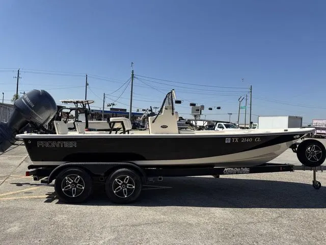 Slide: The Image of 2014 Frontier Boats 2104 on trailer, parked outdoors under clear blue sky. - 5