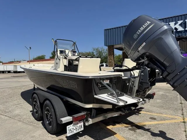 Slide: The Image of 2014 Frontier Boats 2104 with Yamaha engine on trailer in parking lot. - 9