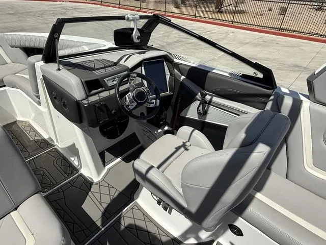 Slide: The Image of 2021 Tigé ZX Class 23 ZX boat interior with modern dashboard and seating. - 12