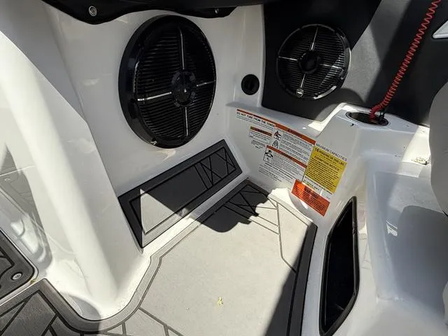 Slide: The Image of Interior of 2021 Tigé ZX Class 23 ZX boat with speakers and safety labels. - 13