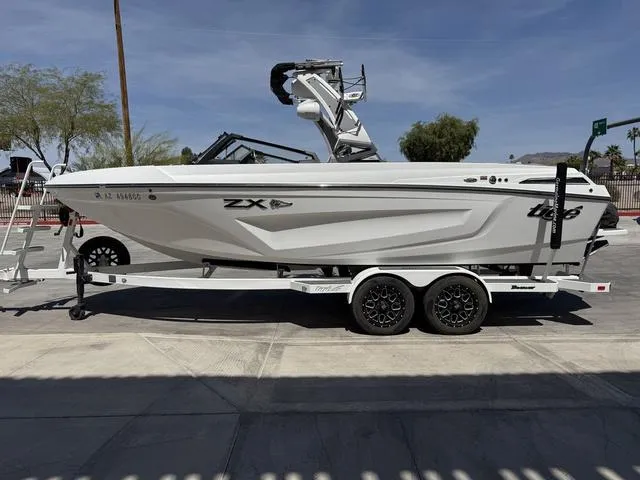 Slide: The Image of 2021 Tigé ZX Class 23 ZX boat on trailer, parked outdoors. - 5