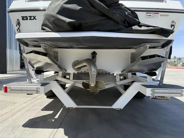 Slide: The Image of 2021 Tigé ZX Class 23 ZX boat rear view, showcasing trailer and exhaust system. - 7