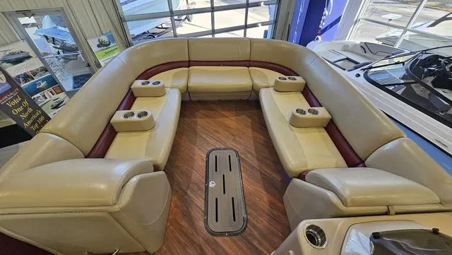 Slide: The Image of 2017 Manitou Aurora 25 LE boat interior with beige seating and cup holders. - 14