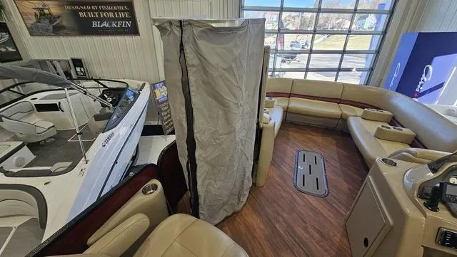 Slide: The Image of 2017 Manitou Aurora 25 LE pontoon boat interior with seating and wood flooring. - 22