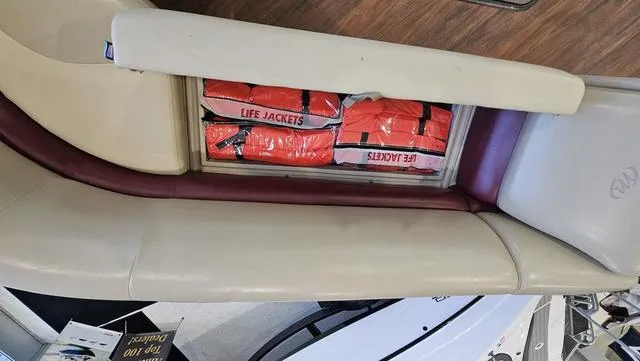 Slide: The Image of Storage compartment with life jackets on a 2017 Manitou Aurora 25 LE boat. - 24