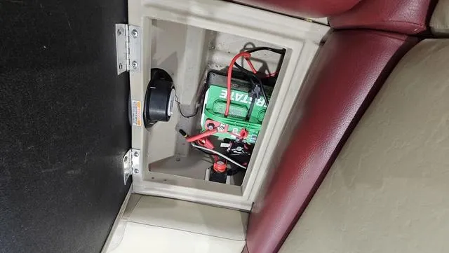 Slide: The Image of Battery compartment of a 2017 Manitou Aurora 25 LE boat with red and black wiring. - 30
