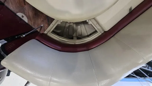 Slide: The Image of 2017 Manitou Aurora 25 LE boat interior with curved seating and storage compartment. - 31