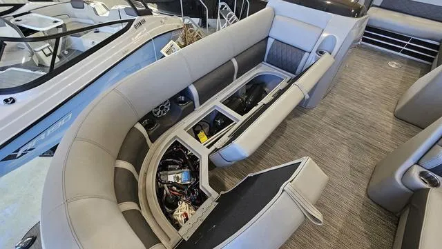 Slide: The Image of 2020 Bennington SX 23 Premium pontoon boat interior with open storage compartments. - 24