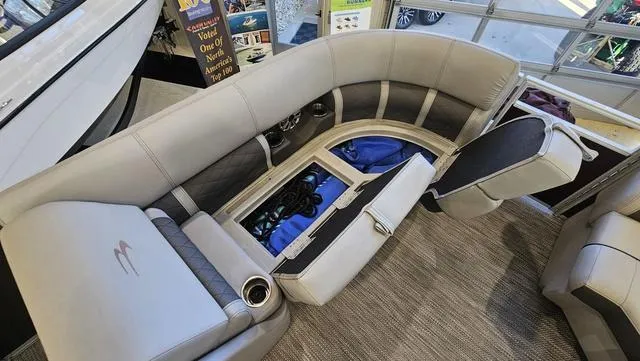 Slide: The Image of 2020 Bennington SX 23 Premium boat interior with open storage compartments and seating. - 25