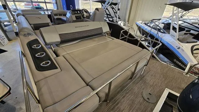 Slide: The Image of 2020 Bennington SX 23 Premium pontoon boat interior with plush seating and cup holders. - 6