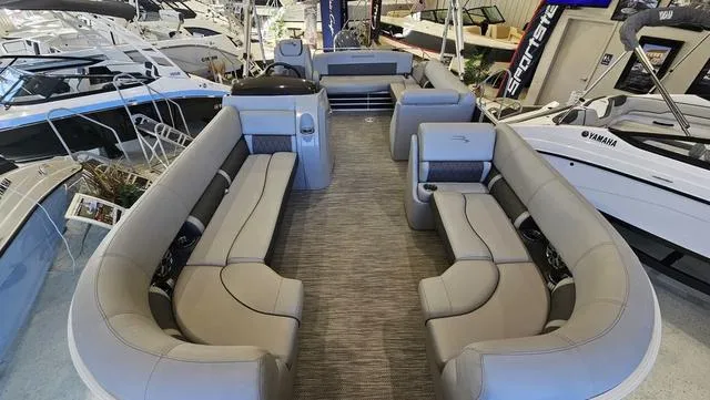 Slide: The Image of 2020 Bennington SX 23 Premium pontoon boat with luxurious seating in a showroom. - 7