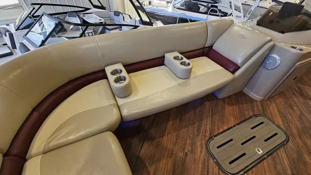 Slide: The Image of Luxurious seating on 2017 Manitou Aurora 25 LE boat with cup holders and wood flooring. - 15