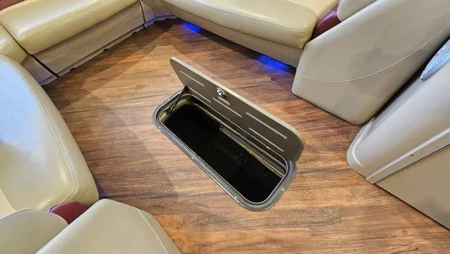 Slide: The Image of 2017 Manitou Aurora 25 LE boat interior with open floor storage compartment. - 23