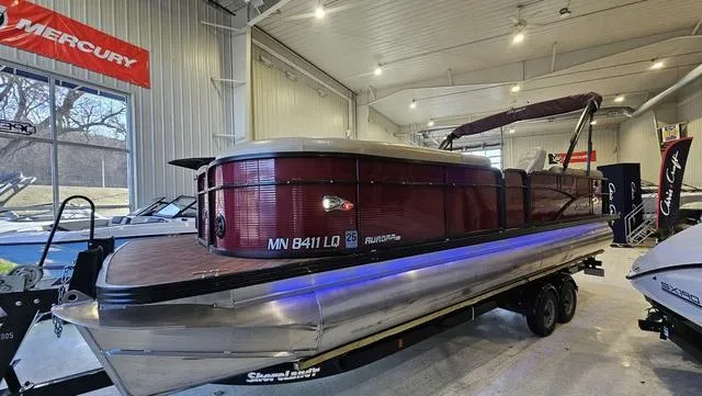 Slide: The Image of 2017 Manitou Aurora 25 LE pontoon boat displayed indoors on a trailer. - 3