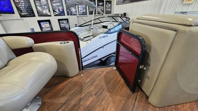 Slide: The Image of 2017 Manitou Aurora 25 LE interior with beige seating and wood flooring. - 32