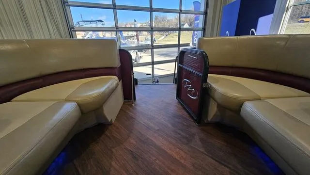 Slide: The Image of Interior of a 2017 Manitou Aurora 25 LE pontoon boat with beige seating and wood flooring. - 34