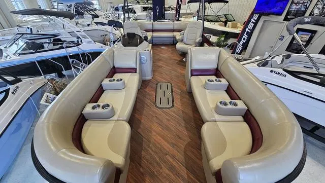 Slide: The Image of 2017 Manitou Aurora 25 LE pontoon boat interior with luxurious seating and cup holders. - 8