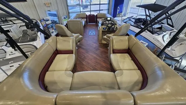 Slide: The Image of 2017 Manitou Aurora 25 LE pontoon boat interior with luxurious seating and modern helm. - 9