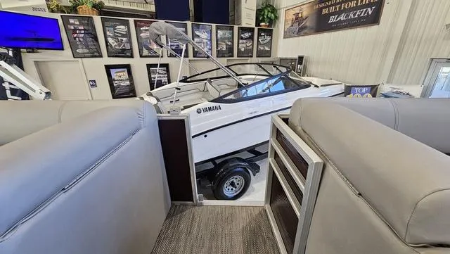 Slide: The Image of 2020 Bennington SX 23 Premium boat displayed indoors with Yamaha engine. - 20