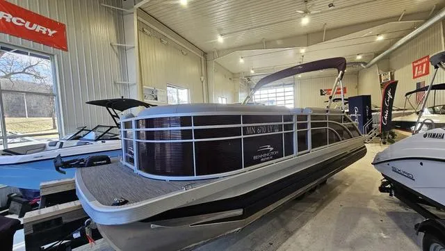 Slide: The Image of 2020 Bennington SX 23 Premium pontoon boat displayed in a showroom. - 4