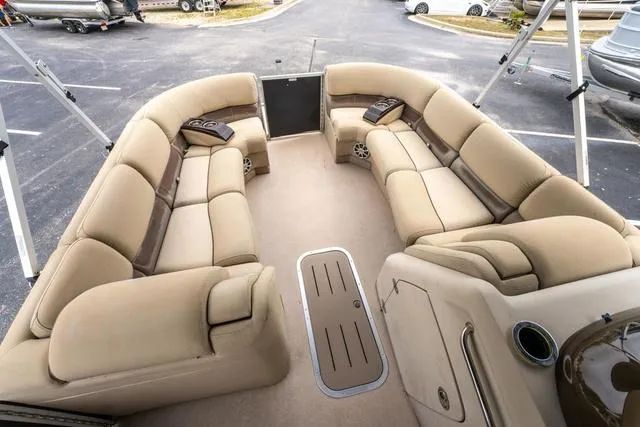 Slide: The Image of 2014 Bennington 2550 RBR boat interior with beige seating and spacious layout. - 12