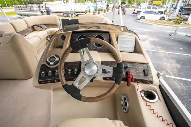 Slide: The Image of 2014 Bennington 2550 RBR boat interior with steering wheel and control panel. - 22