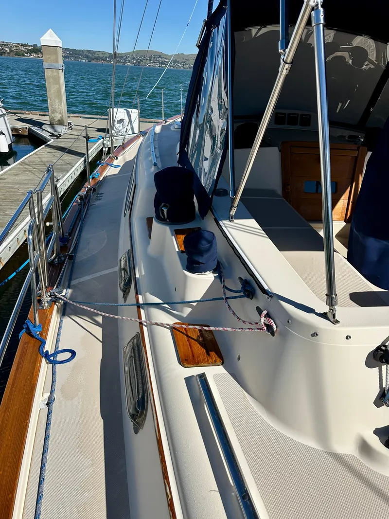 Slide: The Image of 2006 Island Packet 485 Center Cockpit sailboat docked, showcasing deck and cockpit area. - 14
