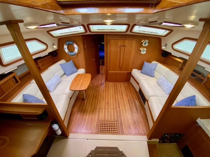 Slide: The Image of Luxurious interior of 2006 Island Packet 485 Center Cockpit yacht with elegant wood finish. - 23