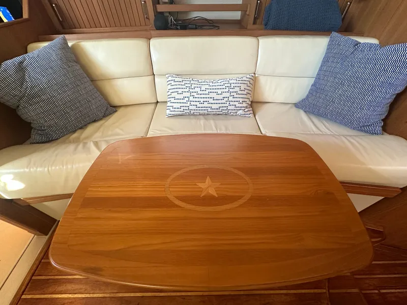Slide: The Image of Luxurious interior of 2006 Island Packet 485 Center Cockpit with elegant wood table and plush seating. - 29