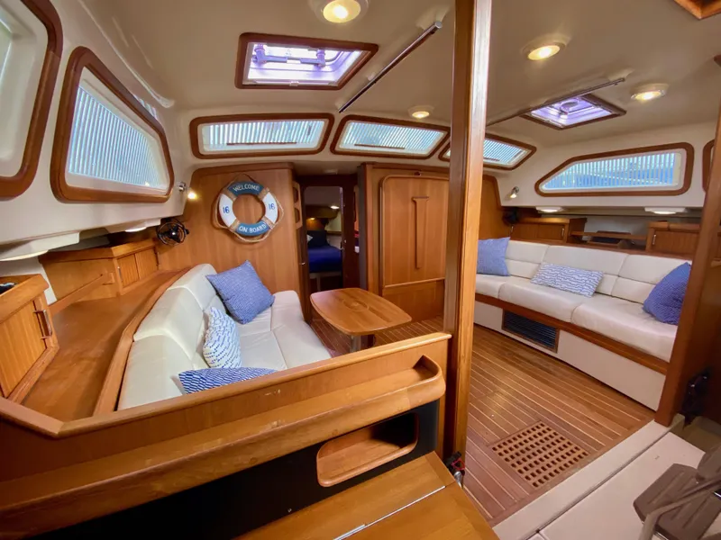 Slide: The Image of Luxurious 2006 Island Packet 485 Center Cockpit interior with plush seating and elegant wood finishes. - 30