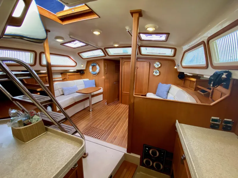 Slide: The Image of Interior of 2006 Island Packet 485 Center Cockpit yacht, featuring cozy seating and wooden finishes. - 31
