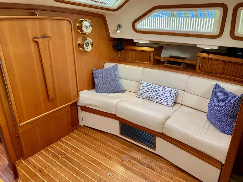 Slide: The Image of 2006 Island Packet 485 Center Cockpit interior with cozy seating and nautical decor. - 32