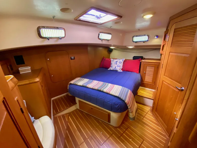 Slide: The Image of Luxurious 2006 Island Packet 485 Center Cockpit cabin with cozy bed and wooden interior. - 45
