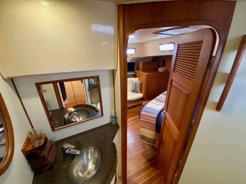 Slide: The Image of Interior of 2006 Island Packet 485 Center Cockpit, featuring bathroom and cozy cabin. - 52