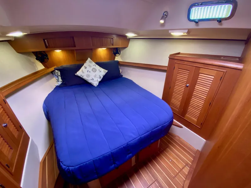 Slide: The Image of Luxurious cabin interior of 2006 Island Packet 485 Center Cockpit yacht with blue bedding. - 54