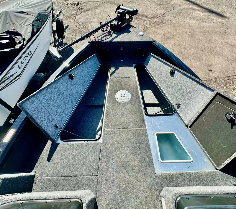 Slide: The Image of 2025 Lund 2075 IMPACT XS boat interior with open storage compartments and fishing equipment. - 16