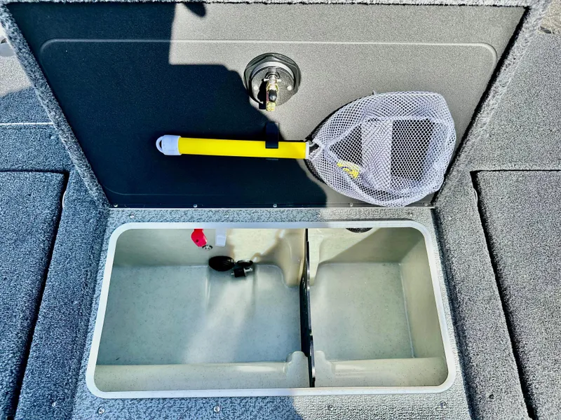 Slide: The Image of 2025 Lund 2075 IMPACT XS boat storage compartment with net and divider. - 17