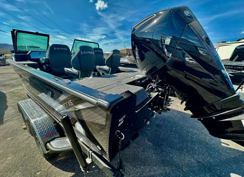 Slide: The Image of 2025 Lund 2075 IMPACT XS boat with powerful outboard motor, sleek design, and spacious seating. - 4