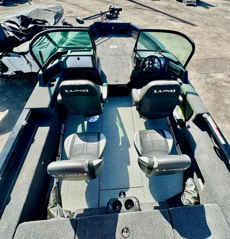 Slide: The Image of 2025 Lund 2075 IMPACT XS boat interior with seating and steering console. - 7