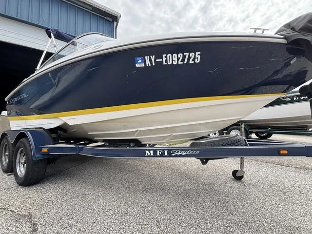 Slide: The Image of 2007 Regal Sport Boat 1900 Bowrider on trailer, parked outside a building. - 2